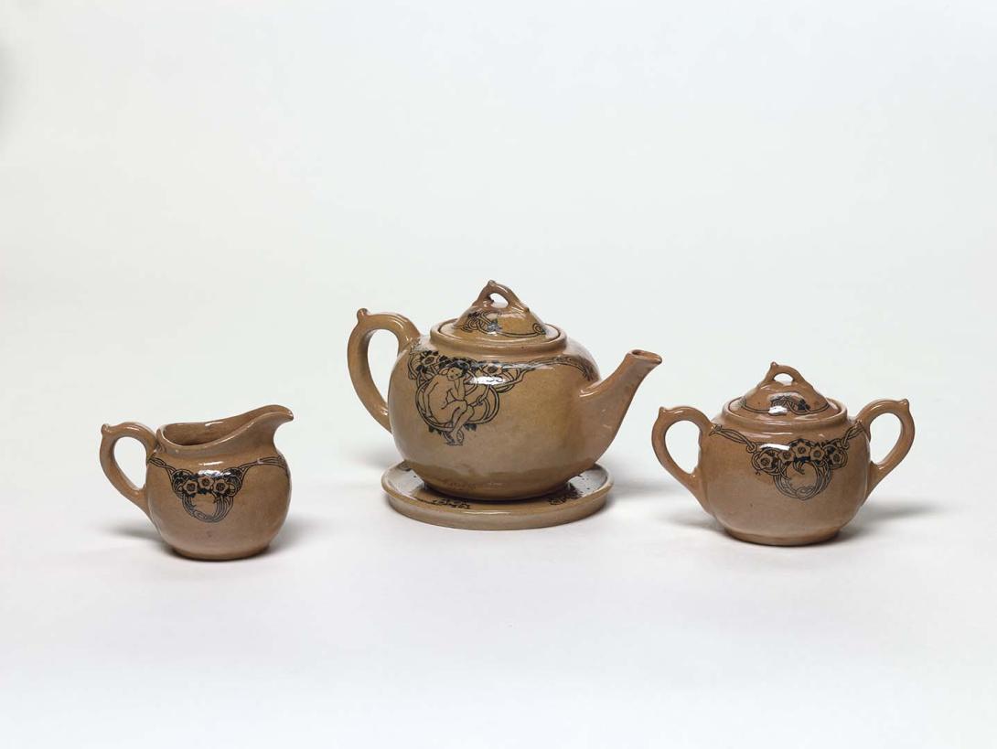 Artwork Tea-set this artwork made of Earthenware, hand-built white clay globular body covered in light brown slip with stylised floral (and figure on teapot) design in underglaze black. Clear glaze, created in 1927-01-01
