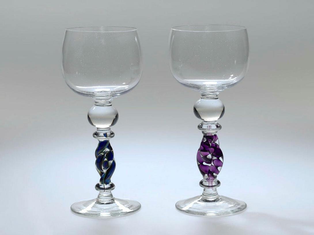 Artwork Two goblets this artwork made of Hot-worked clear glass with spherical bowl and prominent bulbous knop above linked purple and clear twist stem and blue and green double twist stem, created in 1983-01-01