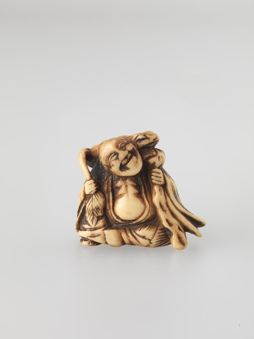 Artwork Netsuke:  (sennin (monk) with a frog on his shoulder) this artwork made of Carved stag-horn, created in 1800-01-01