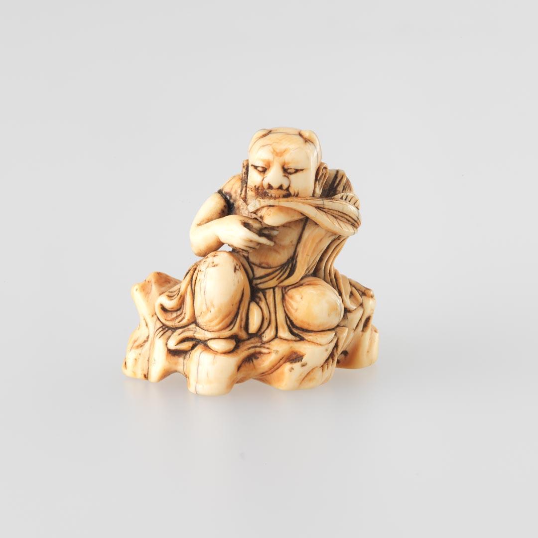 Artwork Netsuke:  (seated demon with leaves in his mouth) this artwork made of Carved ivory, created in 1800-01-01