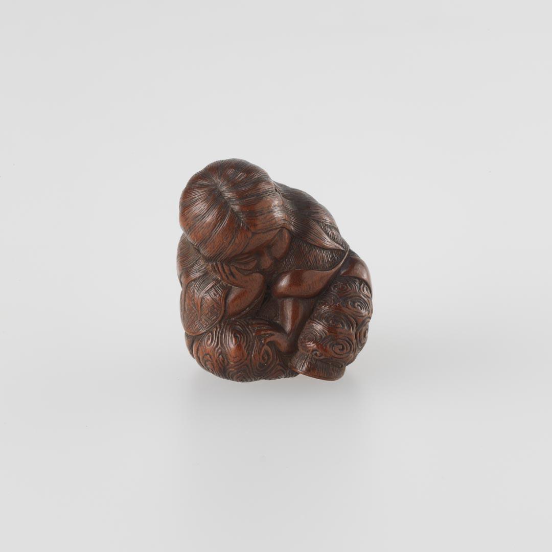 Artwork Netsuke:  (Shojo with long flowing hair) this artwork made of Carved boxwood, created in 1850-01-01