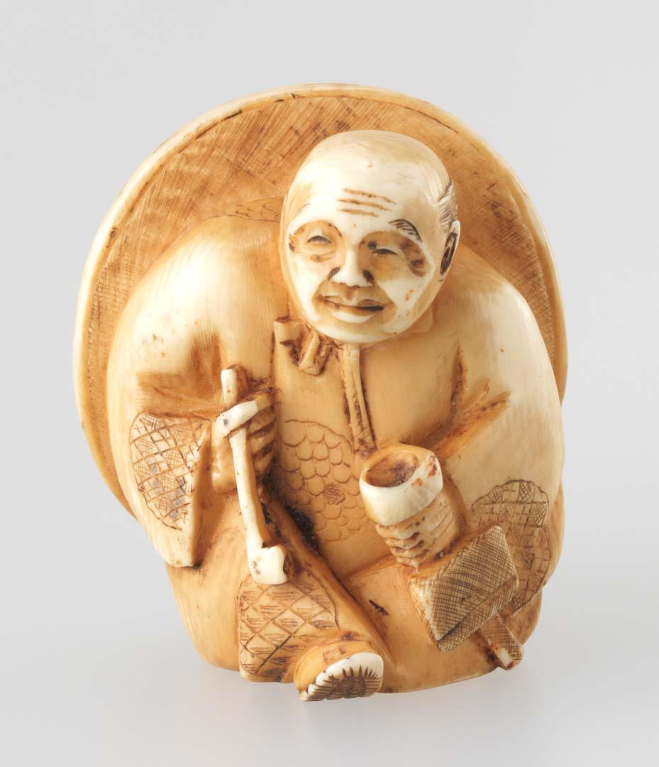 Artwork Netsuke:  (peasant in a large straw hat) this artwork made of Carved ivory, created in 1750-01-01