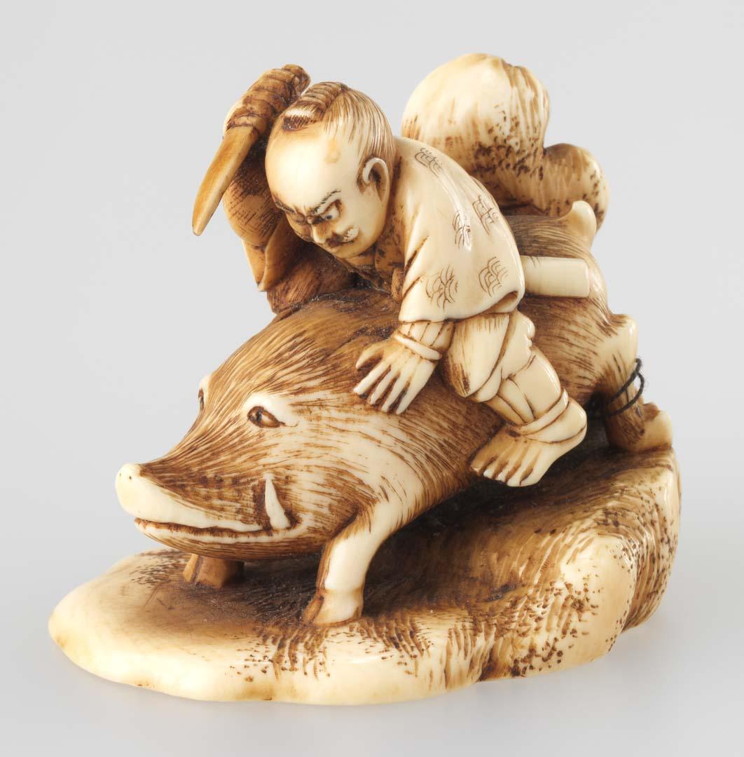 Artwork Netsuke:  (Tadatsune slaying a wild boar) this artwork made of Carved ivory with flat base and inset red lacquer, created in 1850-01-01