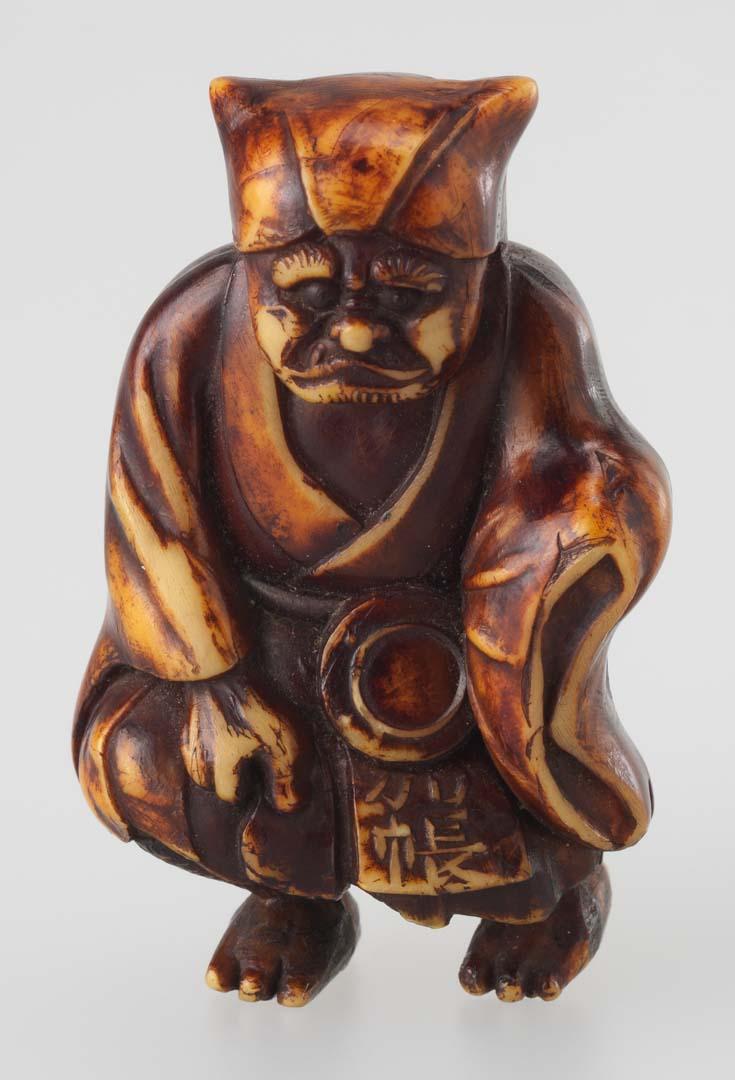 Artwork Netsuke:  (horned demon) this artwork made of Carved and stained ivory, created in 1800-01-01
