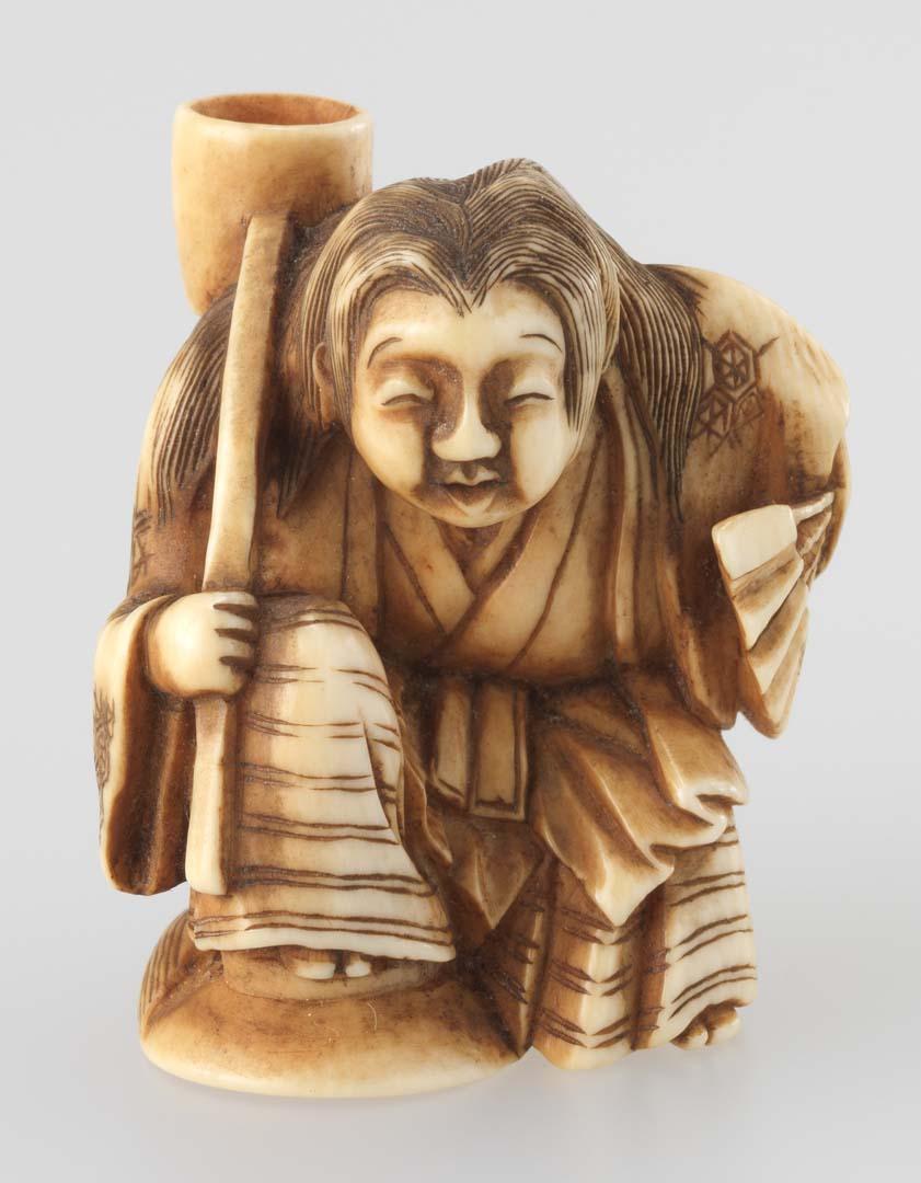 Artwork Netsuke:  (vendor with a basket) this artwork made of Carved ivory, created in 1800-01-01