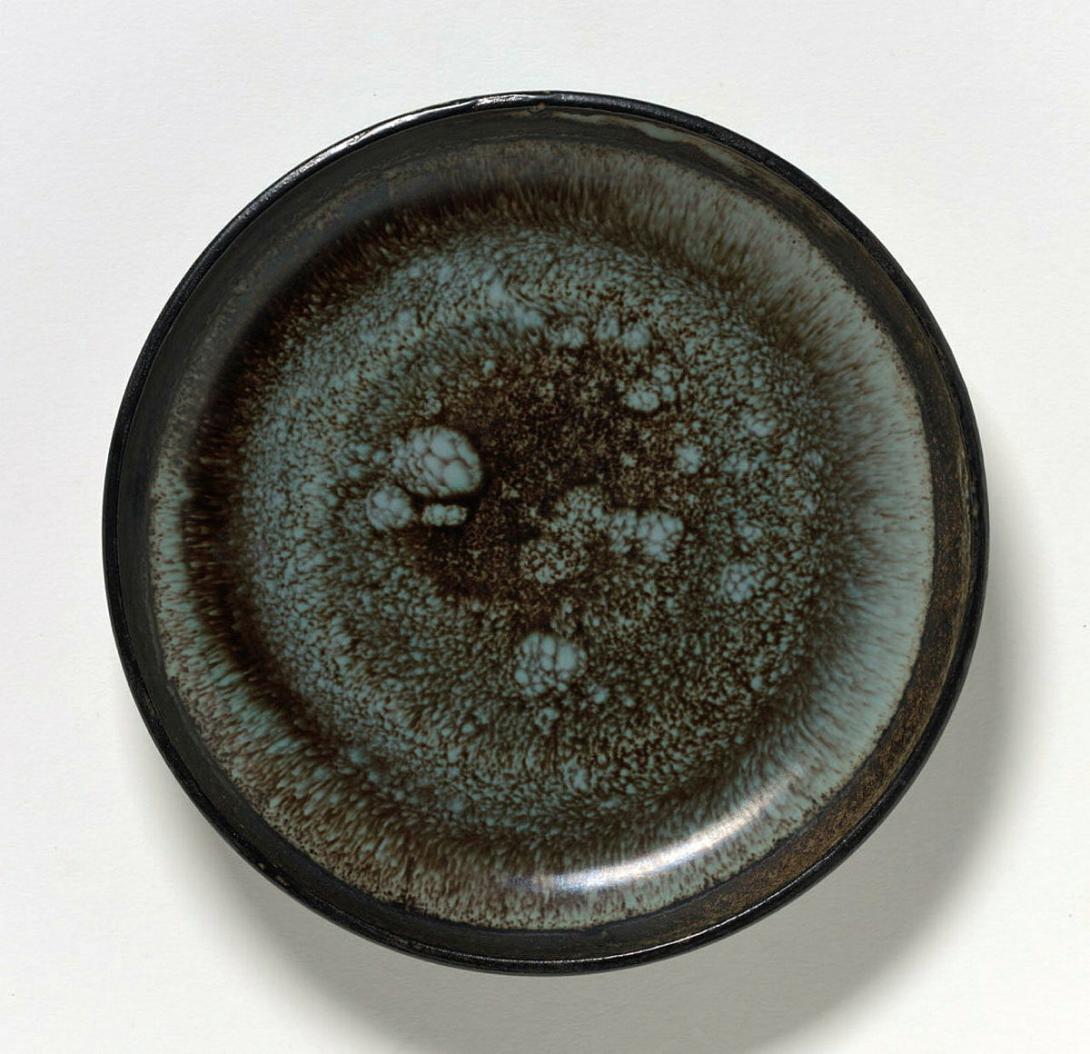 Artwork Plate this artwork made of Circular earthenware plate with mottled green and brown glaze with wide manganese rim, created in 1950-01-01
