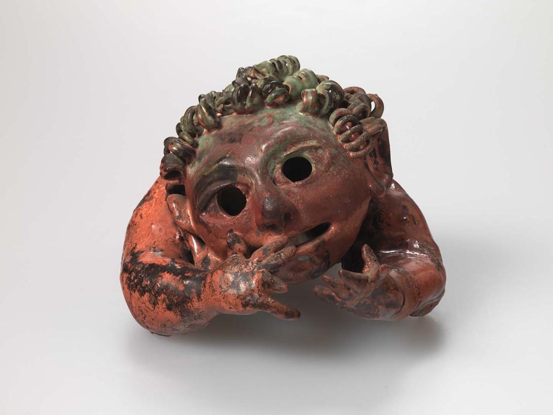 Artwork Wall sculpture:  (Angel) this artwork made of Modelled stoneware in the form of a half figure with coiled hair and hands reaching to its face.  Reduced red and green copper glazes, created in 1955-01-01