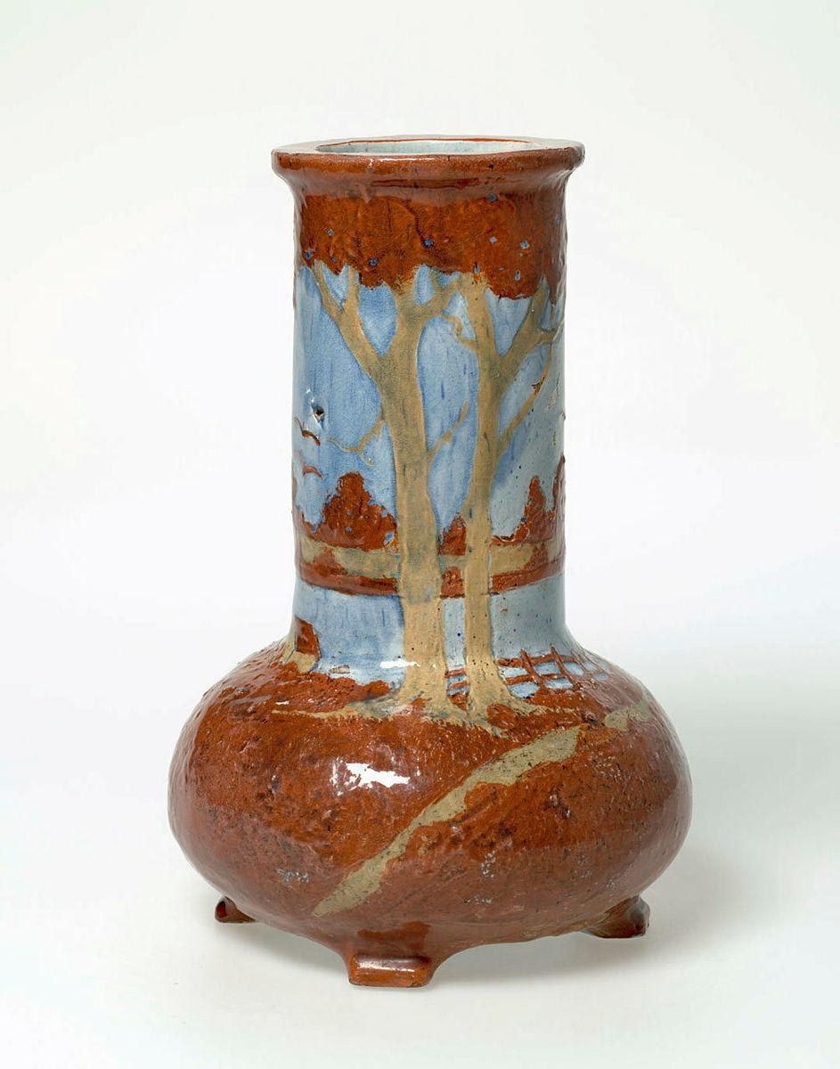 Artwork Onion shaped vase this artwork made of Earthenware, hand-built cylindrical vase with swelling base and four applied feet. Decorated with a landscape scene in buff and rust slips. Light blue glaze (Note: Harvey School exercise No.10), created in 1929-01-01