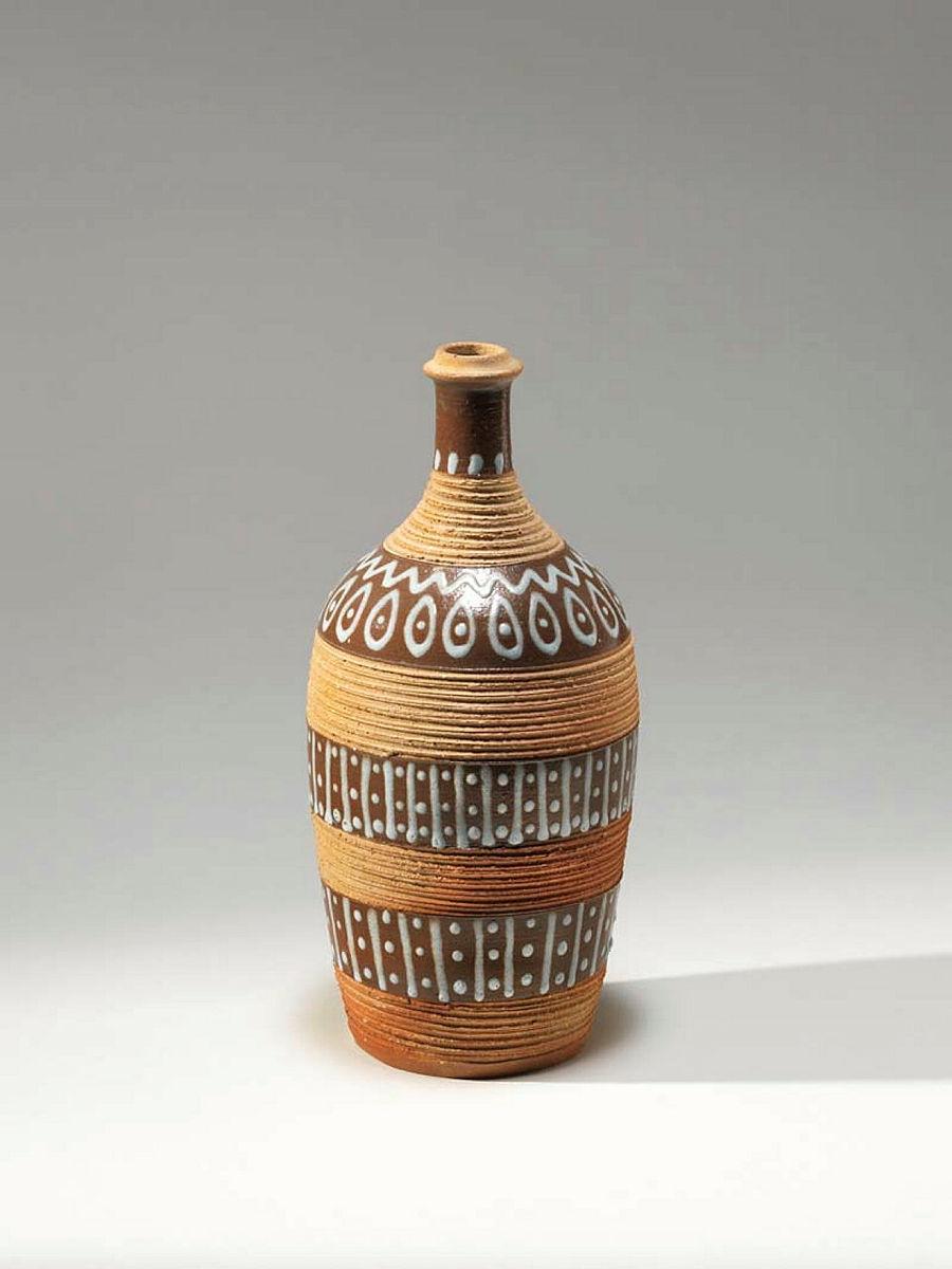 Artwork Bottle this artwork made of Earthenware, thrown with bands of incisions around body. Trail decorated with two bands of lines and dots, with ovals and dots around the neck, created in 1948-01-01