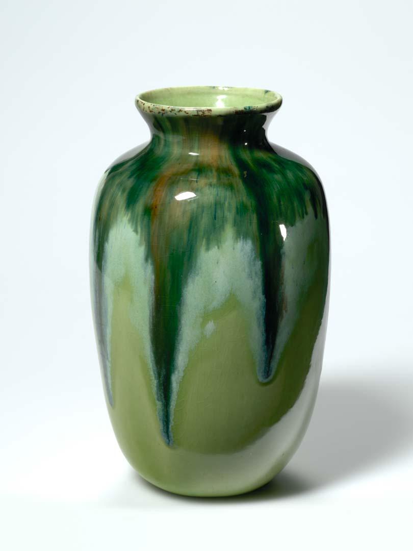 Artwork Vase this artwork made of Slip-cast white earthenware clay of baluster shape with two shades of green running over a lighter green glaze, created in 1950-01-01