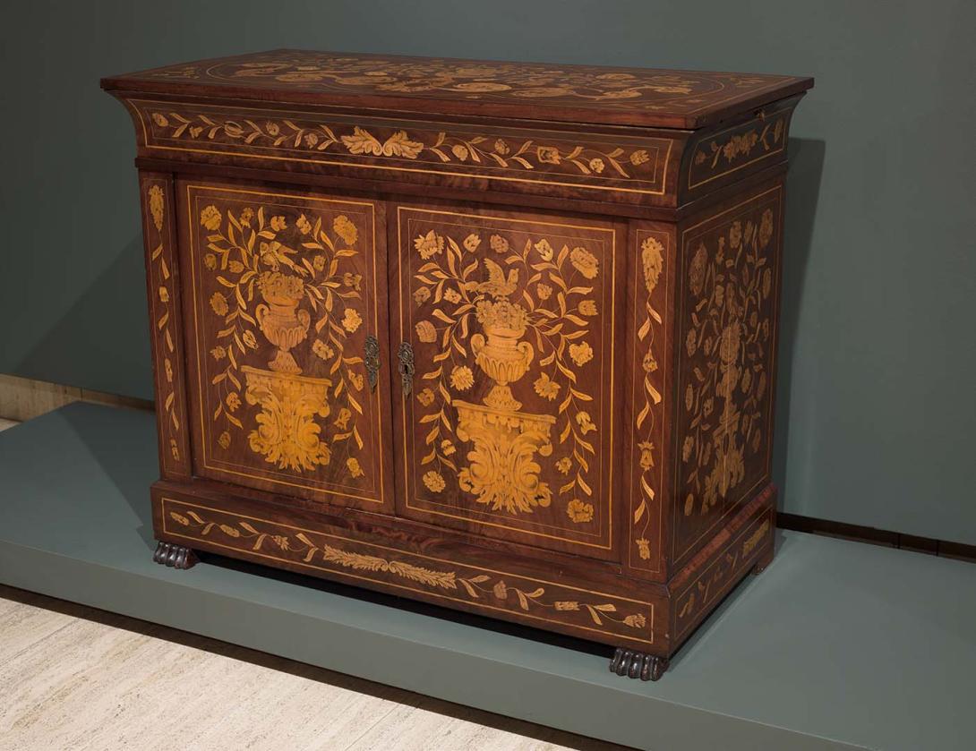 Artwork Dutch Marquetry cabinet this artwork made of Mahogany inlaid on the top, front and sides with stained satinwood vases on brackets containing bunches of flowers and leaves.  Subsidiary decoration of scrolls and leafy trails, created in 1825-01-01