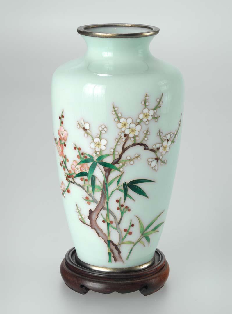 Artwork Cloisonné vase this artwork made of Metal base with enamel decorated with the 'shochikubai' (pine, bamboo and plum) motif in pink, green, white and brown against a pale green ground, created in 1960-01-01