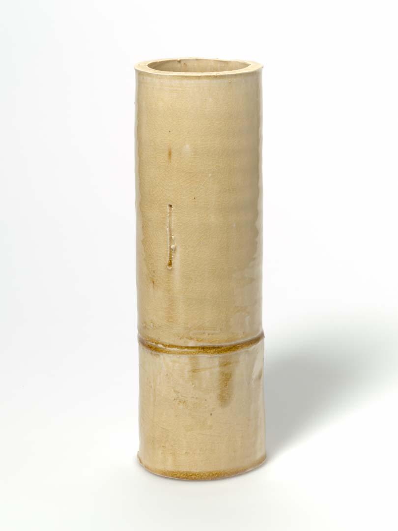 Artwork Bamboo vase this artwork made of Coarse white stoneware in cylindrical form with torn edge and incised lines; yellow Seto glaze, created in 1984-01-01