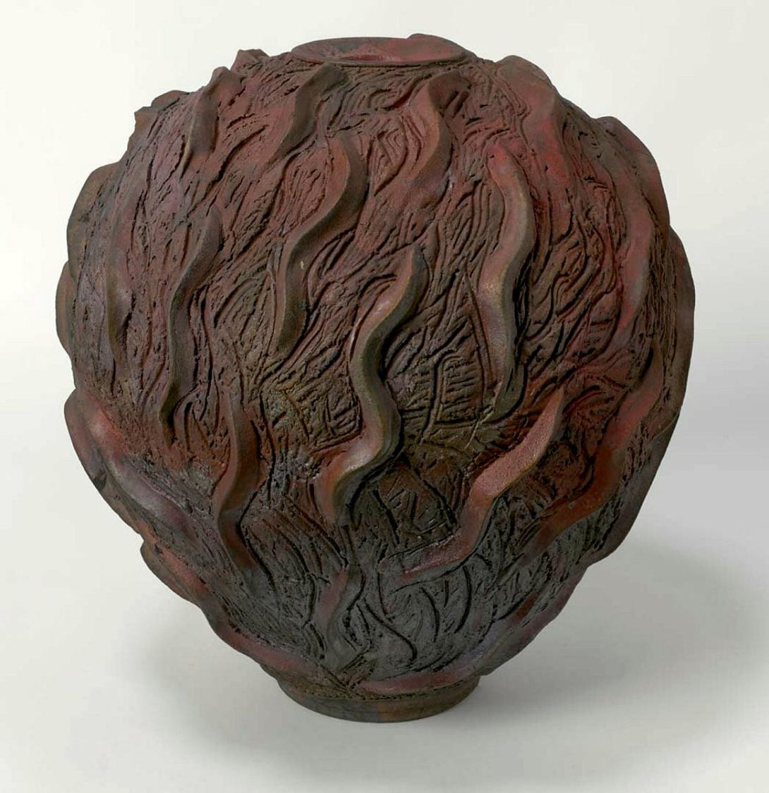 Artwork Raku jar:  Wind form this artwork made of Raku clay, wheelthrown with modelling on surface and metallised glaze, created in 1989-01-01