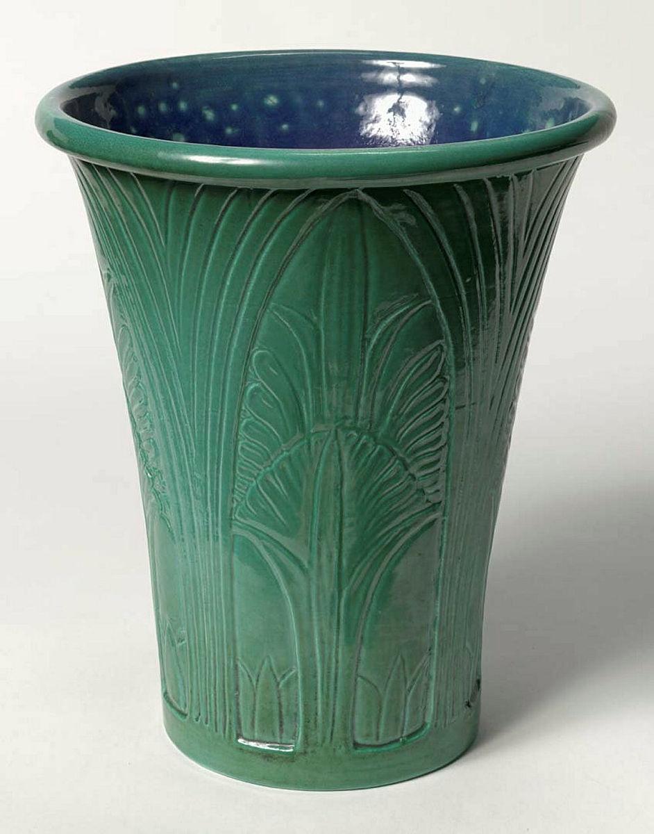 Artwork Vase this artwork made of Earthenware thrown, flared cylindrical vase with incised acanthus leaf decoration and green glaze.  Blue glazed interior, created in 1991-01-01