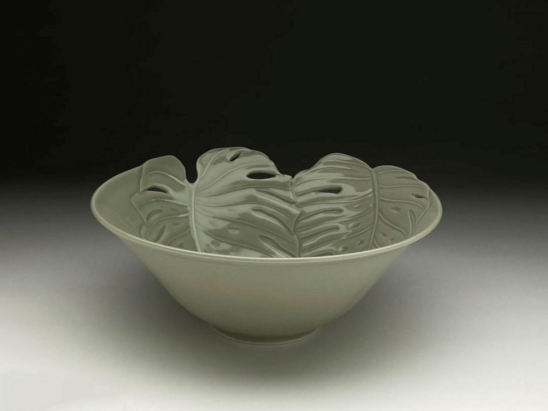 Artwork Bowl:  Monstera this artwork made of Porcelain, wheelthrown, carved and pierced with a motif of monstera leaves, with celadon glaze, created in 1992-01-01