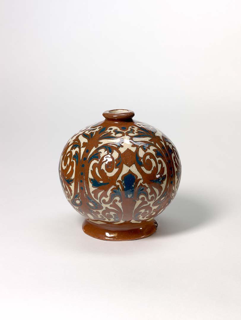 Artwork Spherical vase this artwork made of Hand-built cream earthenware dipped dark red slip and carved with scrolls in the neo renaissance manner.  Cobalt details beneath clear glaze, created in 1935-01-01