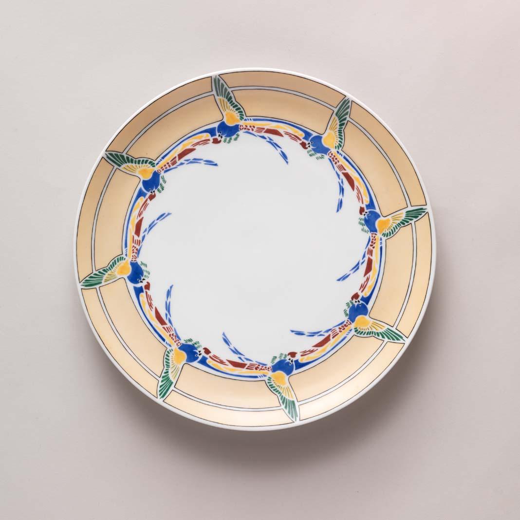 Artwork Plate:  Scissor birds this artwork made of Hard paste porcelain blank decorated in cream, yellow, black, red, blue and green overglaze colours, created in 1956-01-01