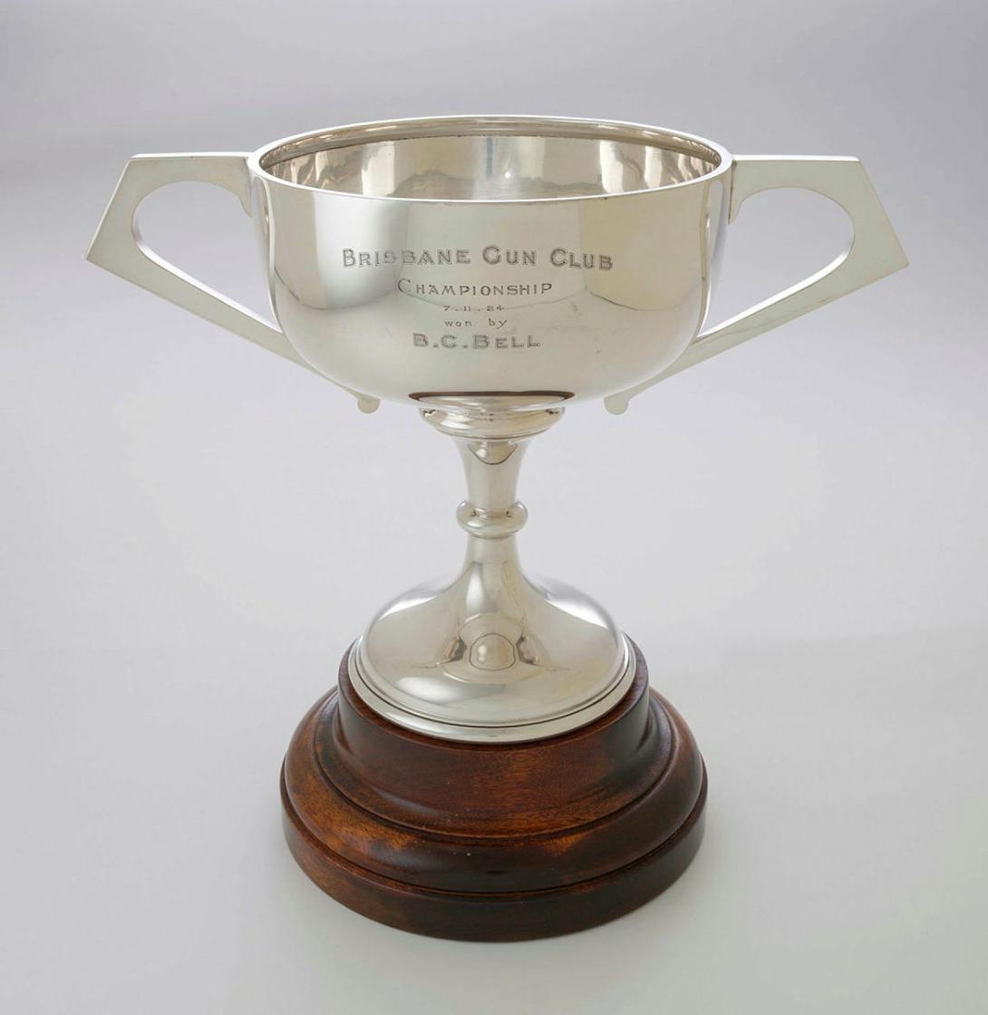 Artwork Presentation cup this artwork made of Silver trophy with two handles on turned stepped Queensland maple base, created in 1922-01-01