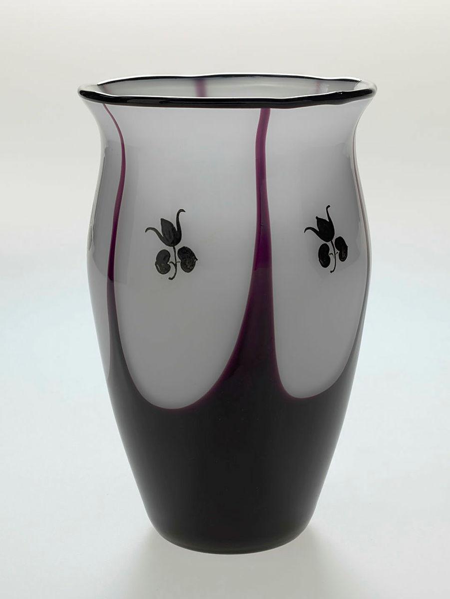 Artwork Vase this artwork made of White glass cased purple with everted six lobed rim.  Wheel-cut panels with floral sprig motif in black, created in 1912-01-01