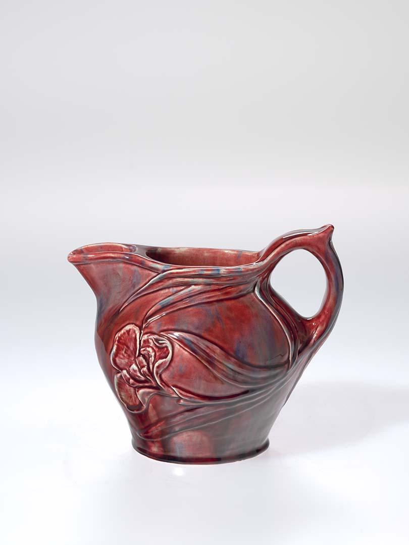 Artwork Lemon squash jug this artwork made of Earthenware, hand built and modelled with iris and leaves, glazed pink and blue, created in 1930-01-01