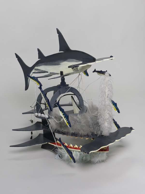 Artwork Beizam headdress (Shark with bait fish) this artwork made of Plywood, enamel paint, wire, feathers, shark's teeth, string