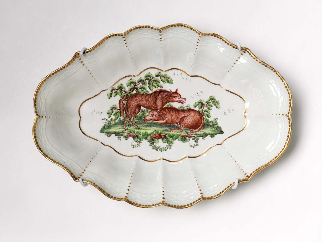 Artwork Lozenge-shaped dish:  (pair of wolves) this artwork made of Soft-paste porcelain, slip-cast scrolled shape with basket weave design, brown and green overglaze, edged with gilt dentil, created in 1768-01-01