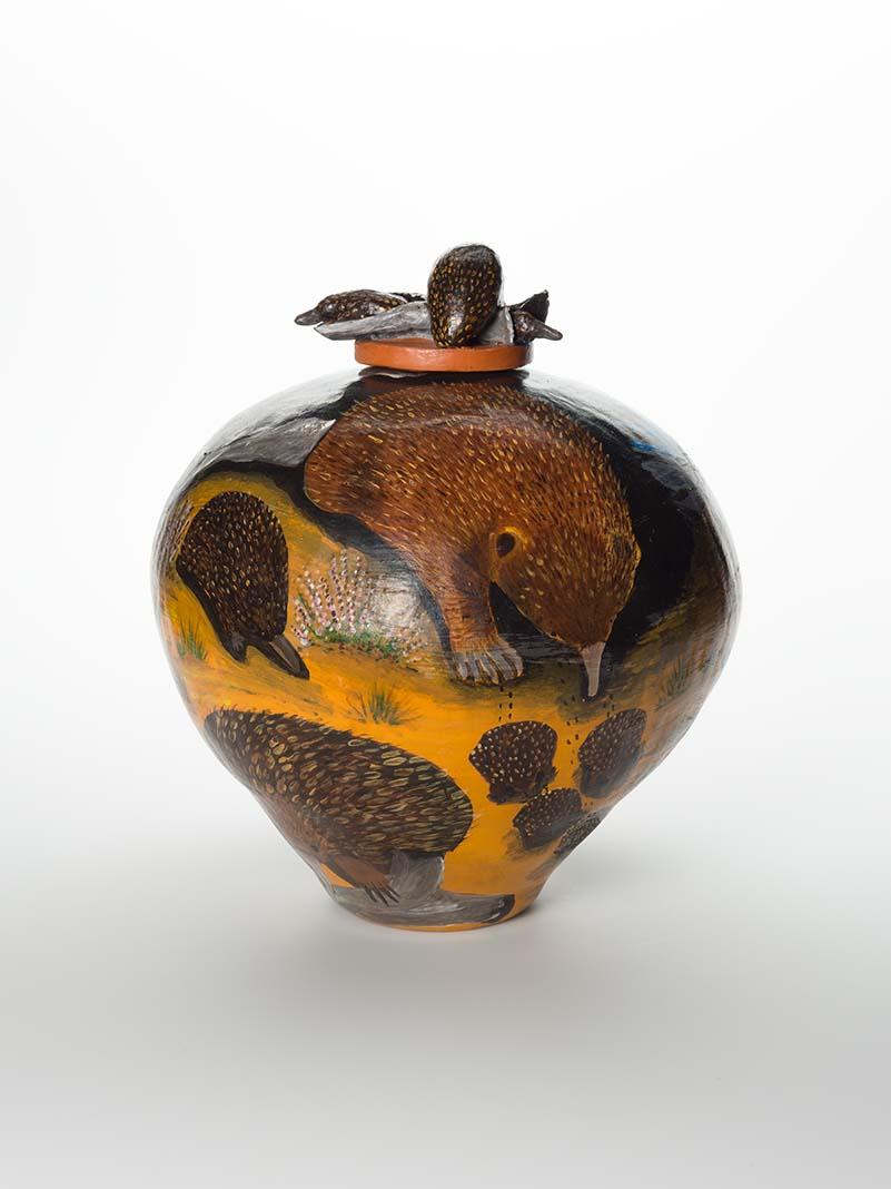 Artwork Pot:  Enalaunga (Echidna) family this artwork made of Earthenware, hand-built terracotta clay with underglaze colours and applied decoration, created in 2004-01-01