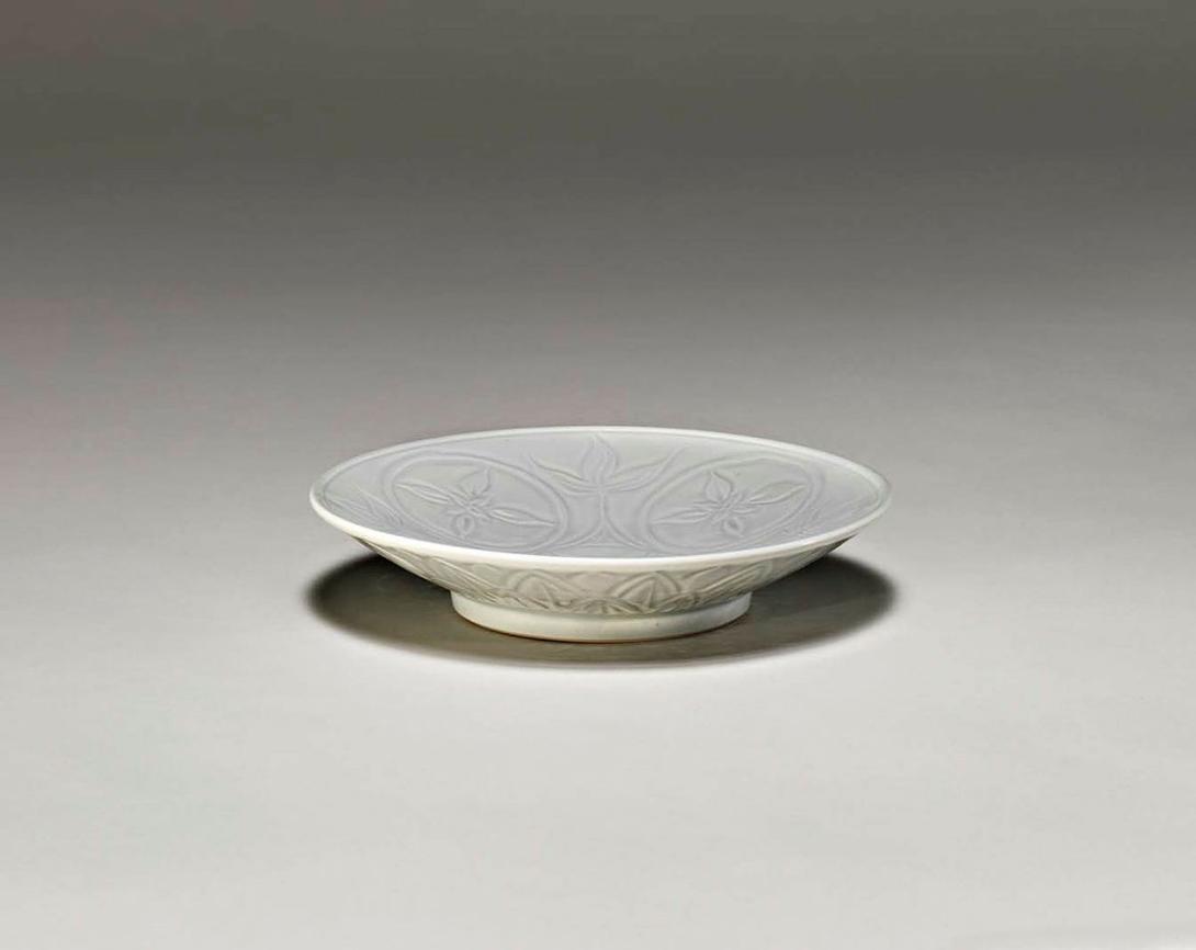 Artwork Dish this artwork made of Porcelain, wheelthrown and carved with five circular floral motifs beneath clear glaze