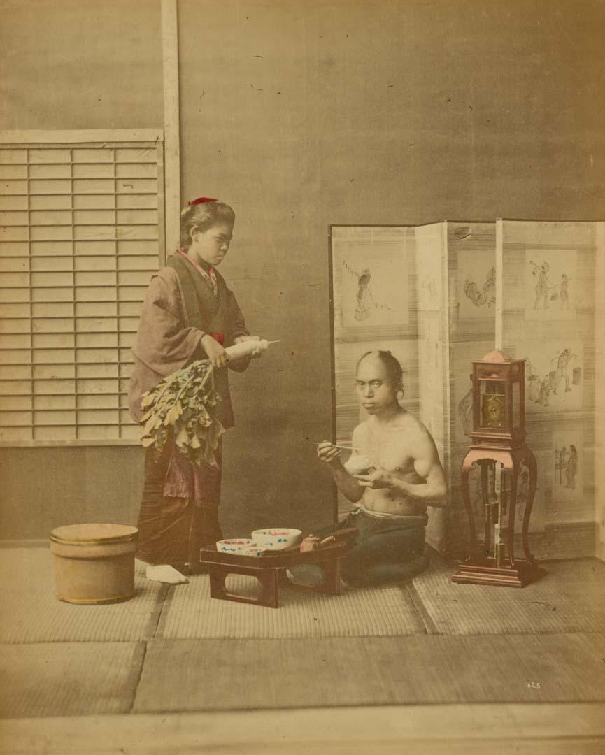 Artwork (Having a meal) (from 'Japan' album) this artwork made of Hand-coloured albumen photograph on board (originally bound in an album), created in 1870-01-01