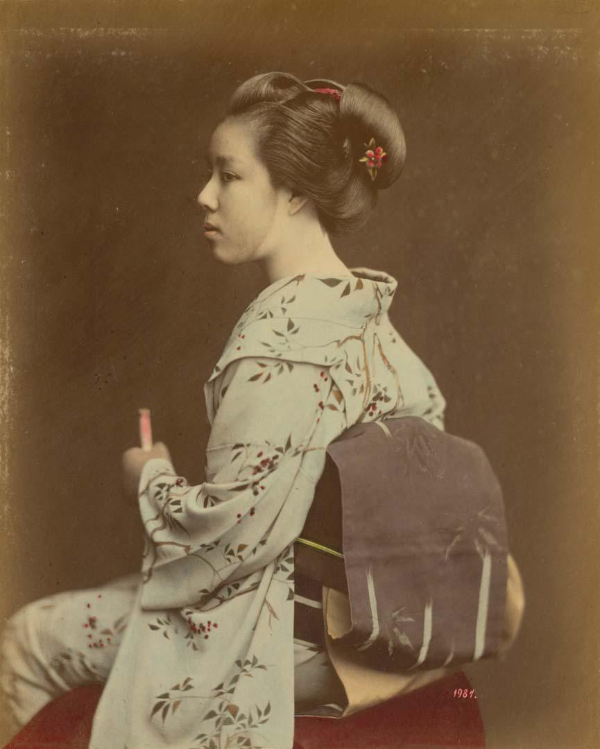 Artwork (Painted-face geisha) (from 'Japan' album) this artwork made of Hand-coloured albumen photograph on board (originally bound in an album), created in 1870-01-01