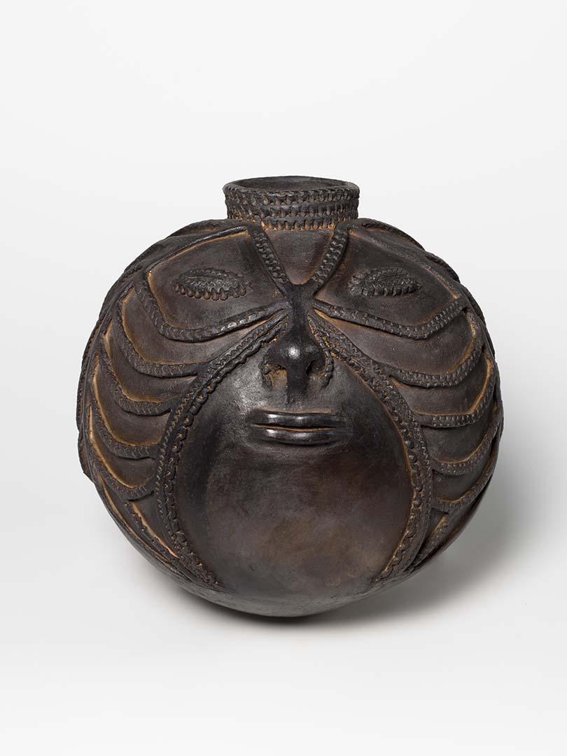 Artwork Water storage pot - woman's face this artwork made of Hand-thrown earthenware with incised decoration and beeswax