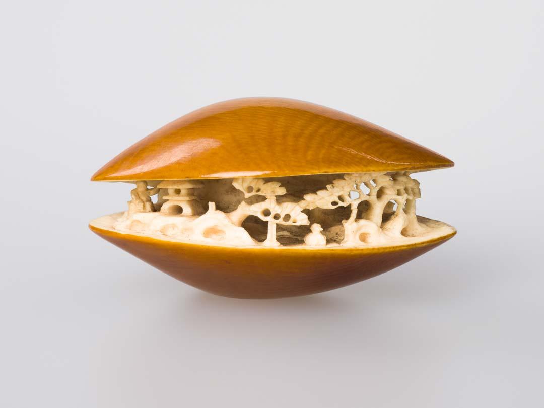 Artwork Netsuke: (garden within an open clam) this artwork made of Carved ivory, created in 1800-01-01