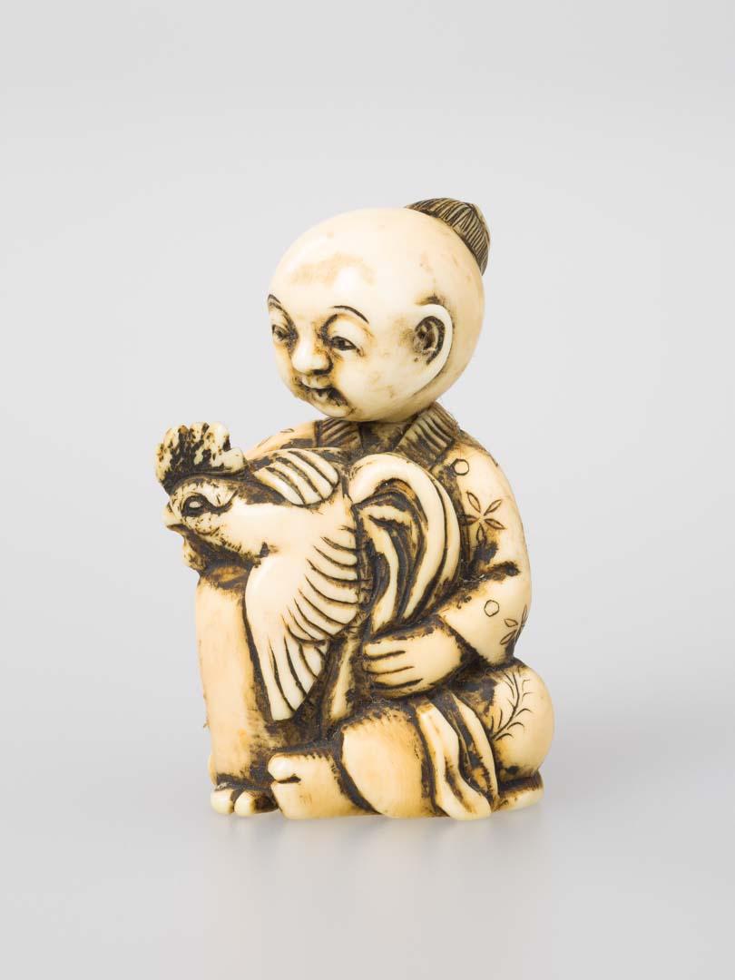 Artwork Netsuke: (figure with bird) this artwork made of Carved ivory, created in 1800-01-01