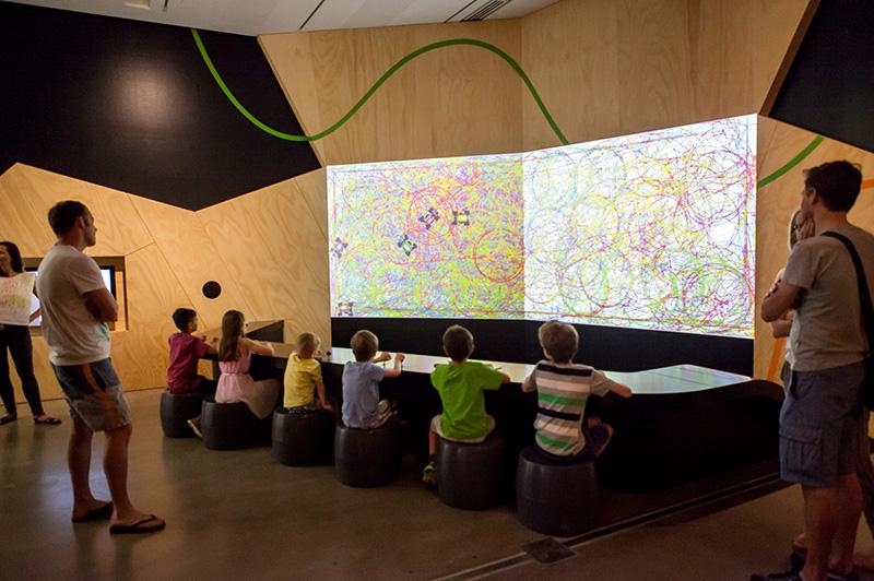 An installation view of children engaging with an APT Kids activity.