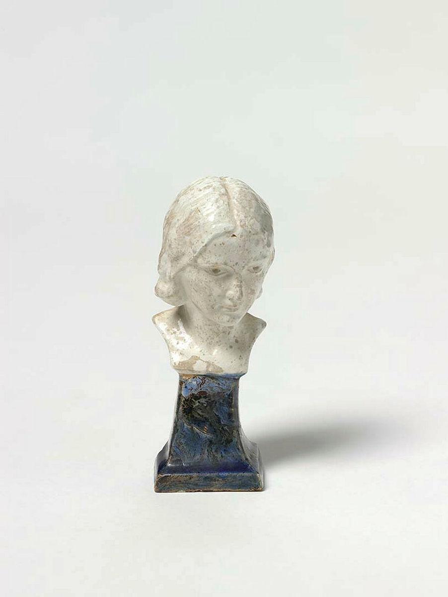 Artwork Head of a girl this artwork made of White clay, modelled with white (imperfectly fired) glaze, and blue glazed mixed clay base, created in 1926-01-01