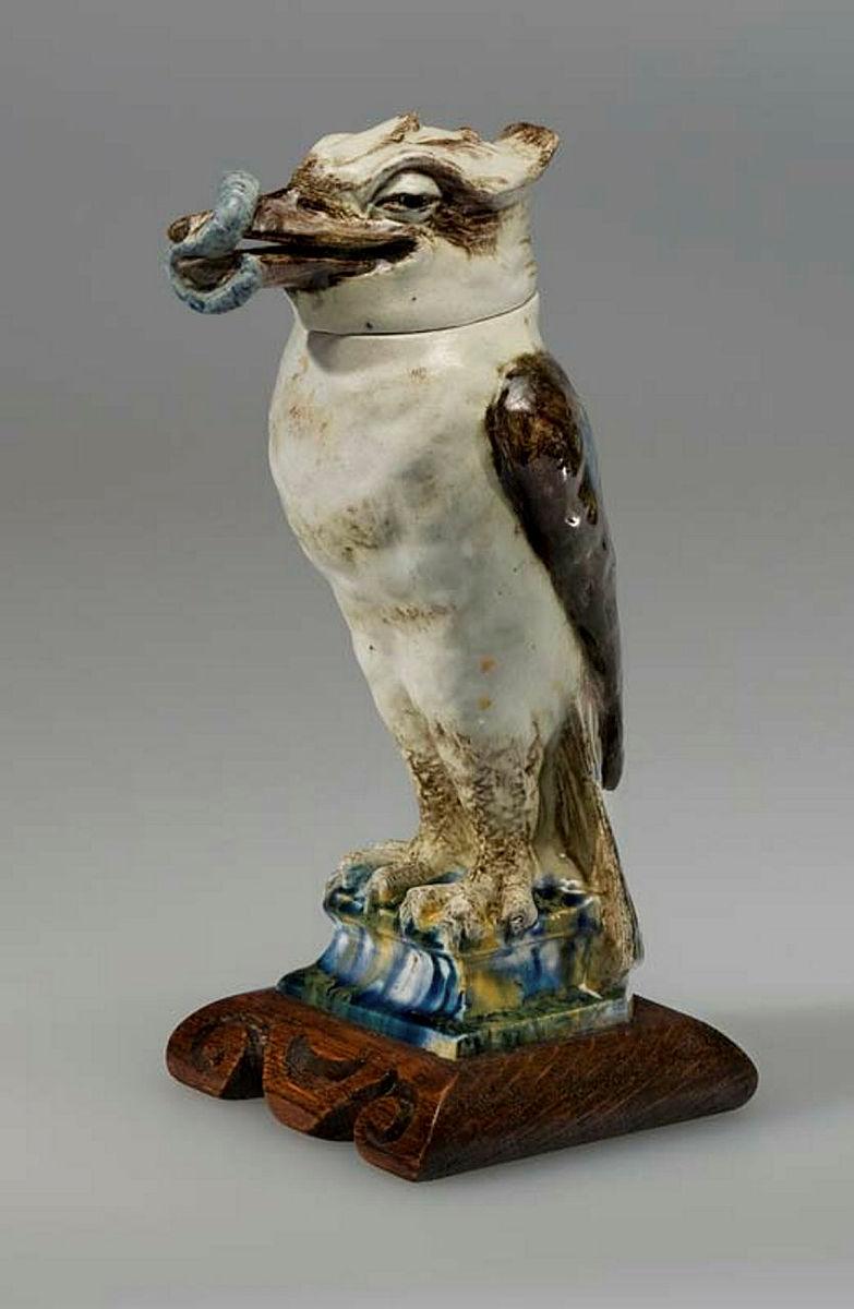 Artwork Jackie tobacco this artwork made of Earthenware, modelled kookaburra, with detachable head, on pedestal, in the style of Martin Bros, England. Glazed naturalistic colours and integral carved wood base, created in 1925-01-01