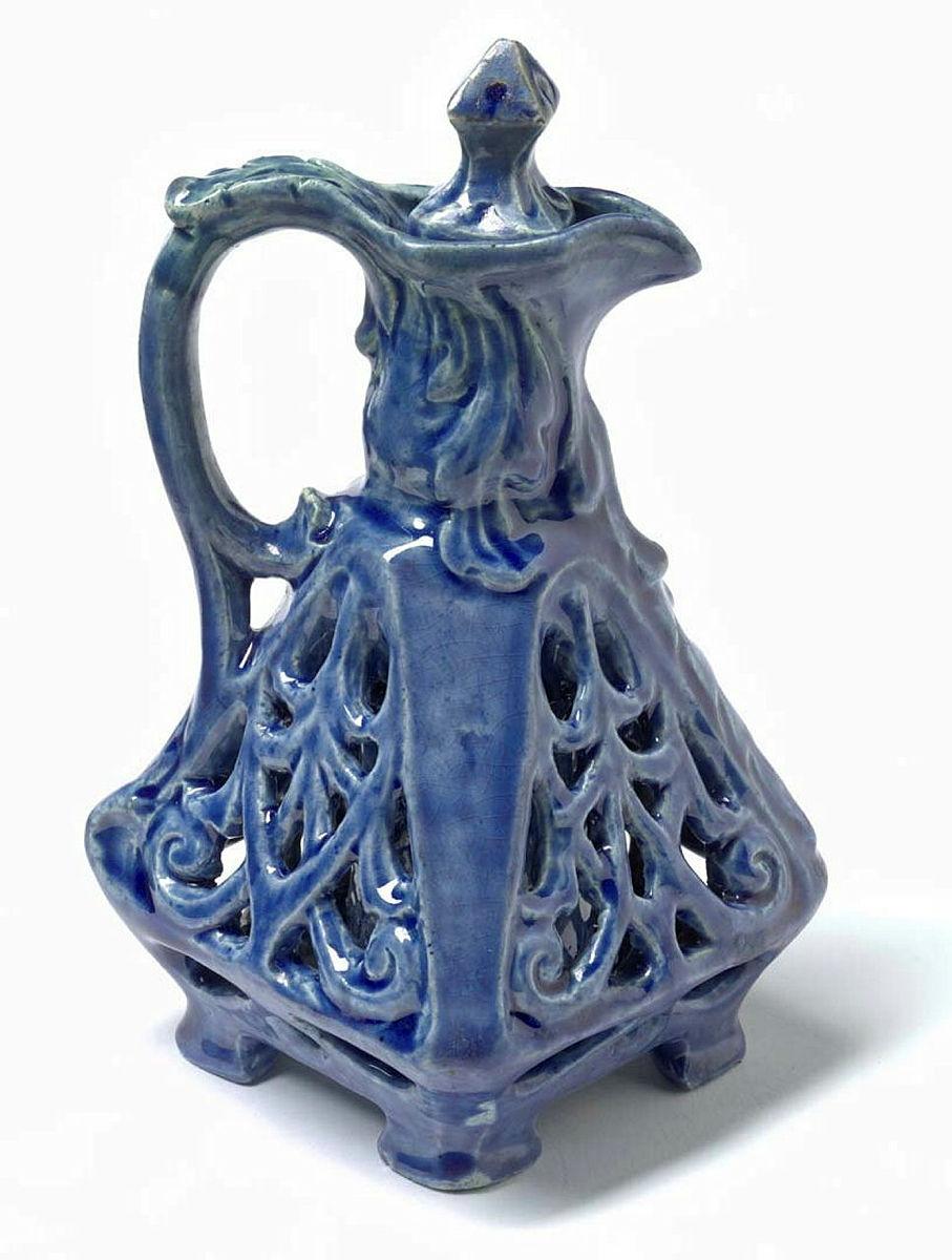 Artwork Double-walled jug this artwork made of Earthenware, hand-built four-sided form with pierced outer surface and blue glaze, created in 1933-01-01