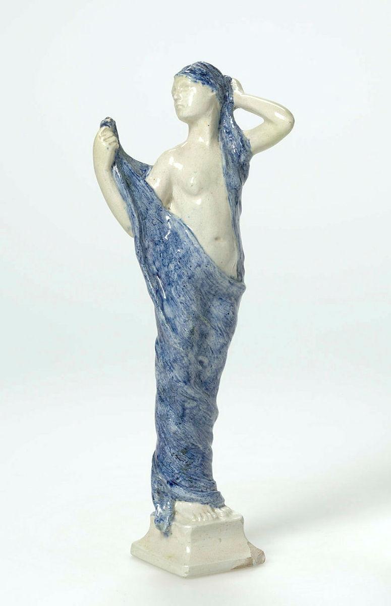 Artwork Female figure this artwork made of Earthenware, modelled as nude woman partially draped with a blue painted cloth. Clear glaze, created in 1932-01-01