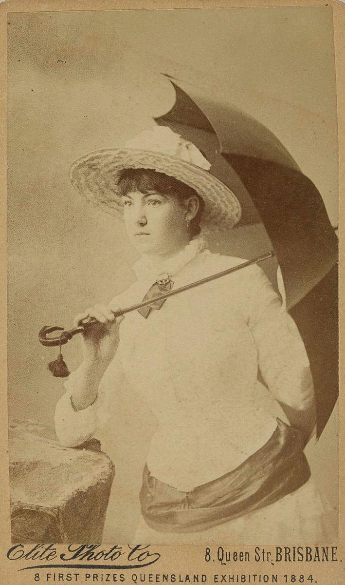 Artwork (Young woman with parasol) this artwork made of Albumen photograph on paper mounted on card, created in 1884-01-01