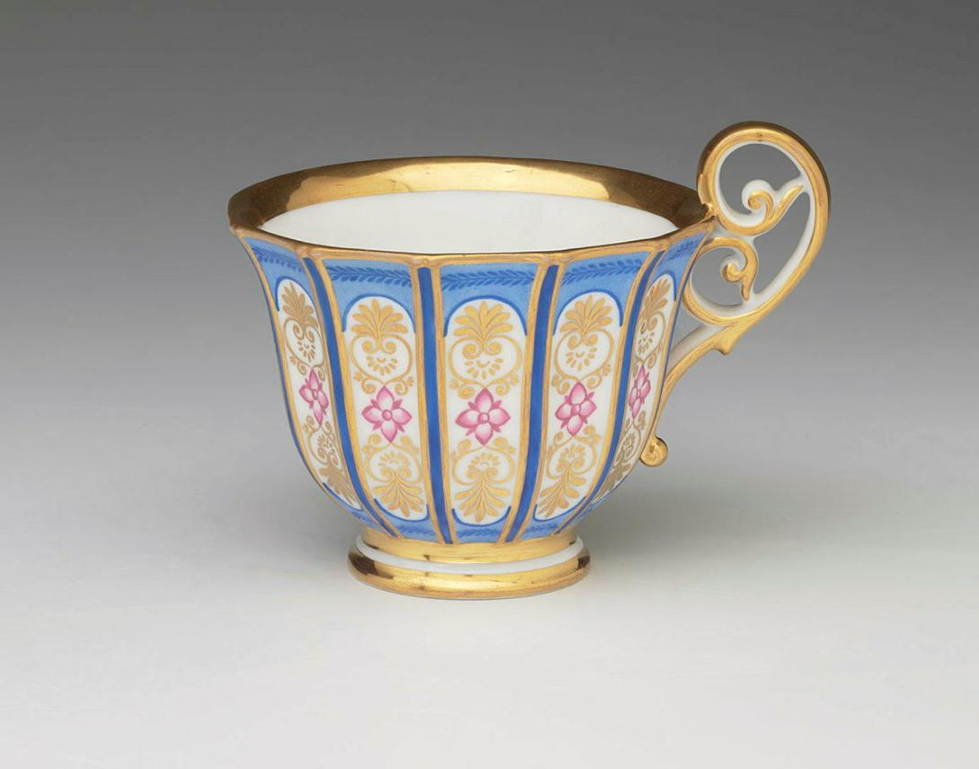 Artwork Cup and saucer this artwork made of Hard-paste porcelain, the saucer divided into fourteen segments enclosing pink flowers and gilt details reserved on mid blue ground with cobalt decorations. Gilt trims, created in 1810-01-01