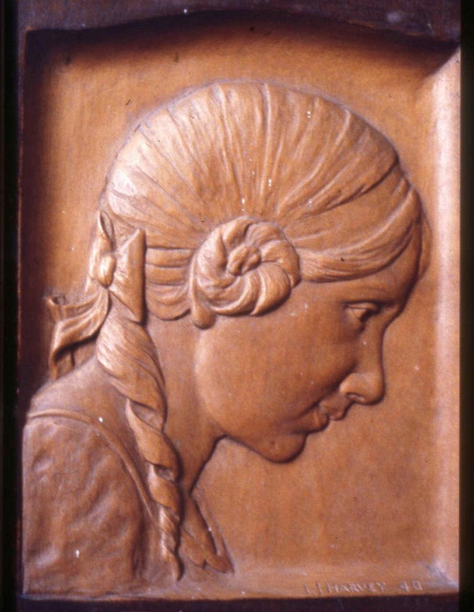 Artwork Plaque:  (female profile) this artwork made of Beech, carved bas relief, created in 1940-01-01