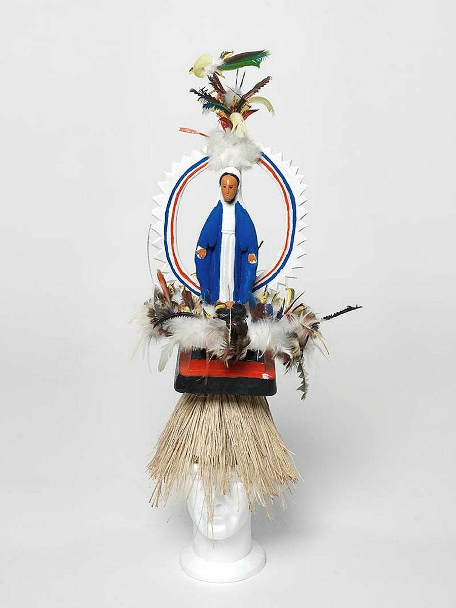 Artwork Mary this artwork made of Tokatokoi, headdress: wood, feathers, plastic Virgin Mary figurine, synthetic polymer paint, grass fibre, created in 2011-01-01