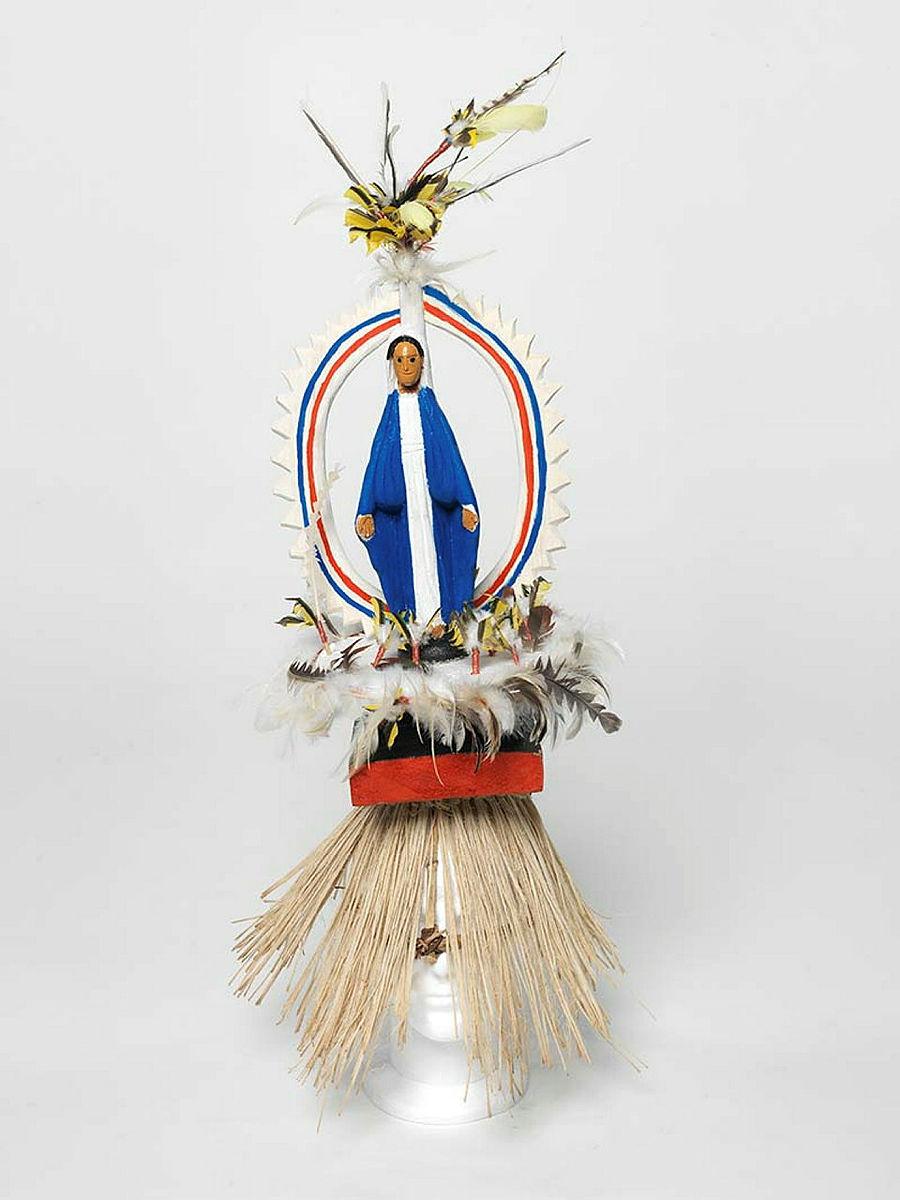 Artwork Mary this artwork made of Tokatokoi, headdress: wood, feathers, plastic Virgin Mary figurine, synthetic polymer paint, grass fibre, created in 2011-01-01