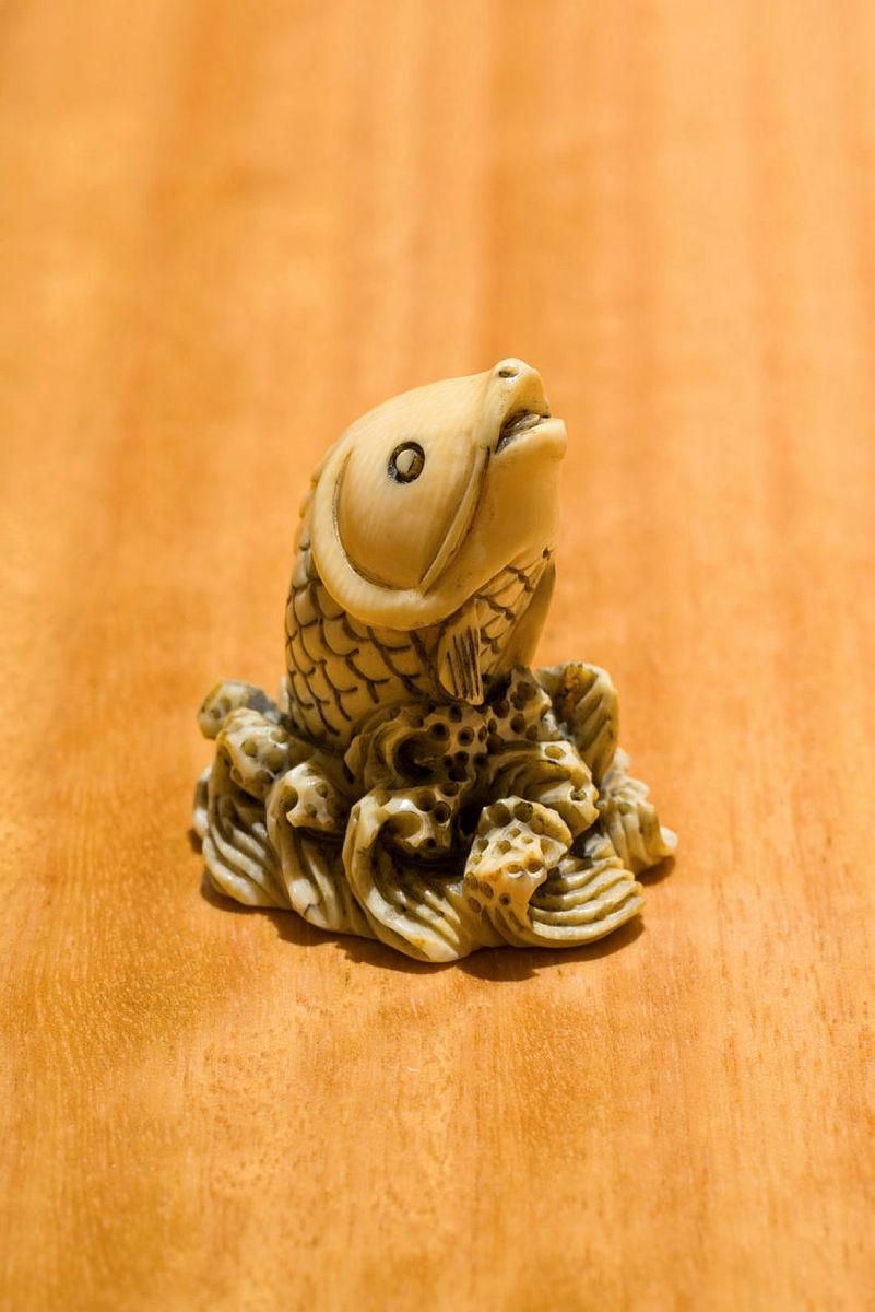 Artwork Netsuke: (fish emerging from waves) this artwork made of Carved ivory, created in 1800-01-01