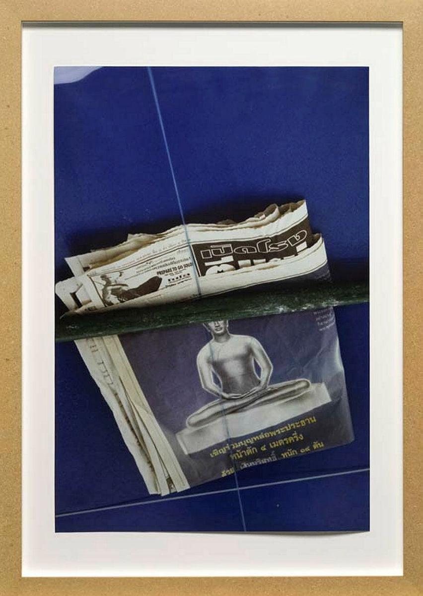 Artwork Untitled (Buddha newspaper) this artwork made of Ultra-glossy type C photograph on paper in medium density fibreboard frame, created in 1998-01-01
