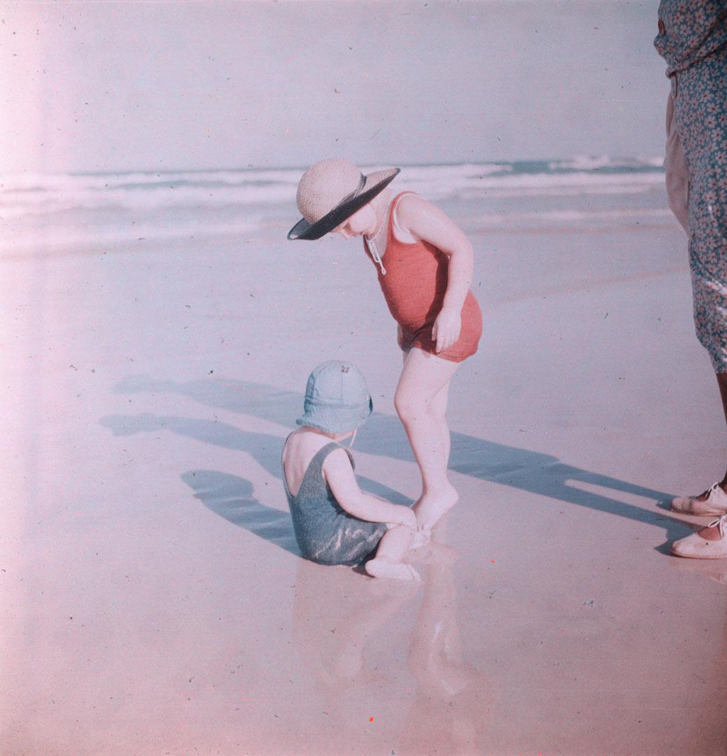 Artwork (Rosemary and Margaret with hats, playing on the sand) this artwork made of Cellulose acetate Dufay colour transparency (originally in a glass mount)