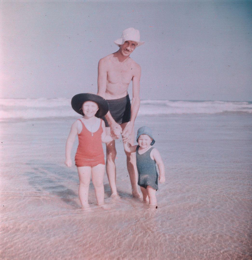Artwork (J.H. Simmonds, Rosemary and Margaret standing in shallow water) this artwork made of Cellulose acetate Dufay colour transparency (originally in a glass mount), created in 1935-01-01