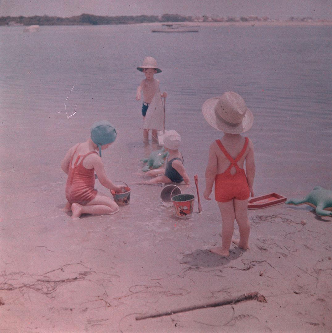 Artwork (Rosemary and three other children playing with a toy boat, with a boy in a red costume in the foreground) this artwork made of Cellulose acetate Dufay colour transparency (originally in a glass mount), created in 1935-01-01