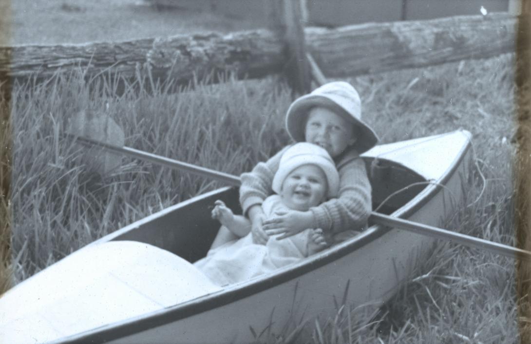 Artwork (Rosemary and Margaret in a canoe on land near a fence) this artwork made of Glass transparency